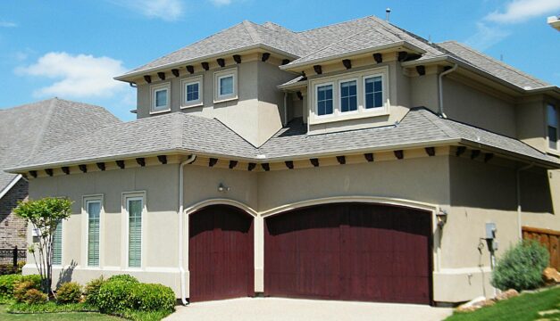 Spanish Style Home with wood garage doors mequon